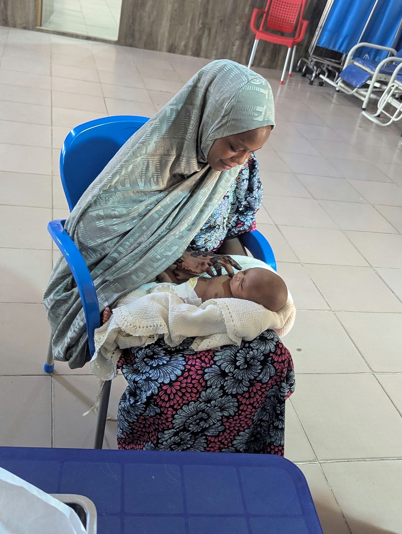 A mother holding her newborn on the Kangaroo Care ward in Kano